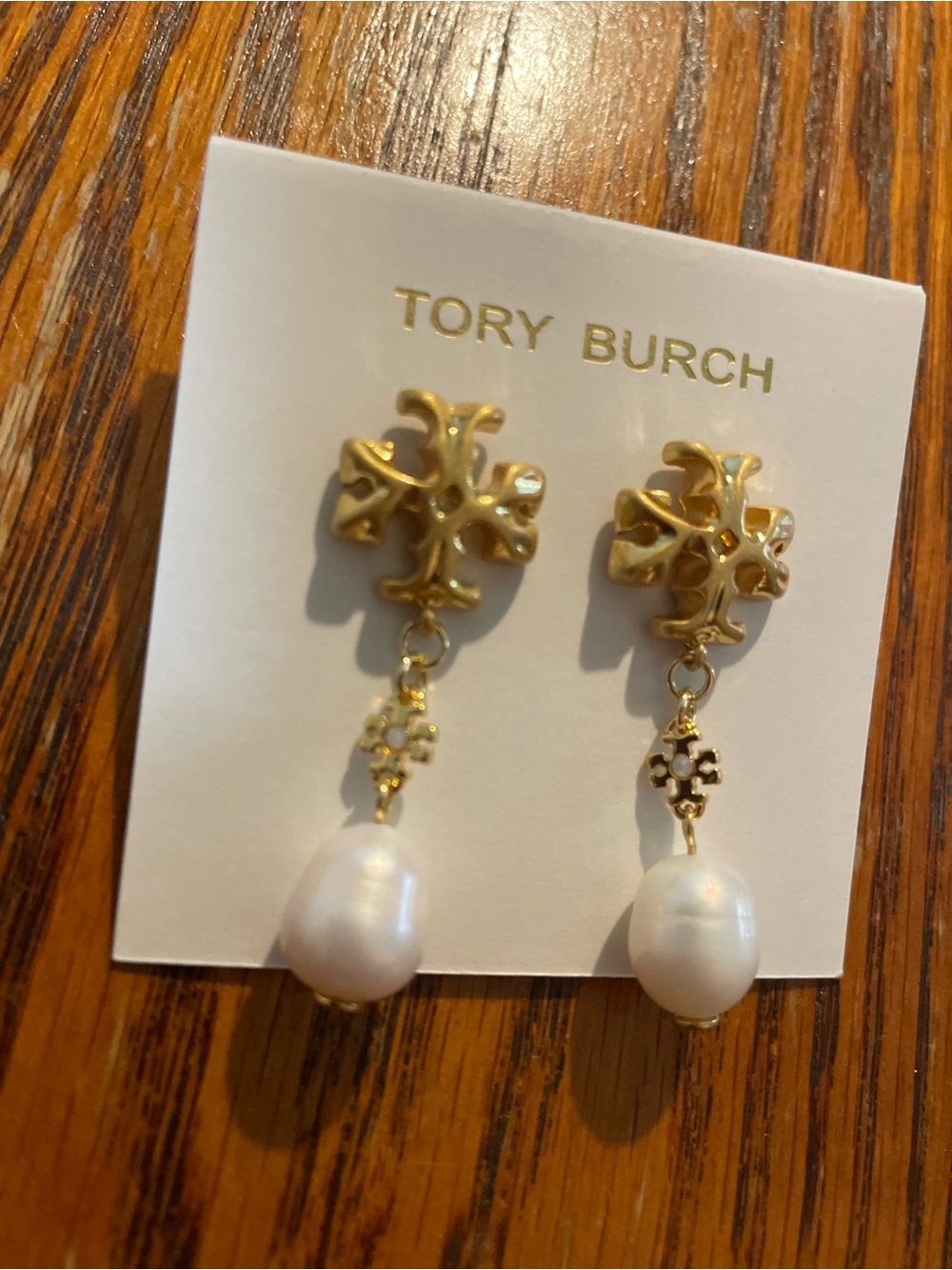 Brand new pearl-drop earrings by Tory Burch.